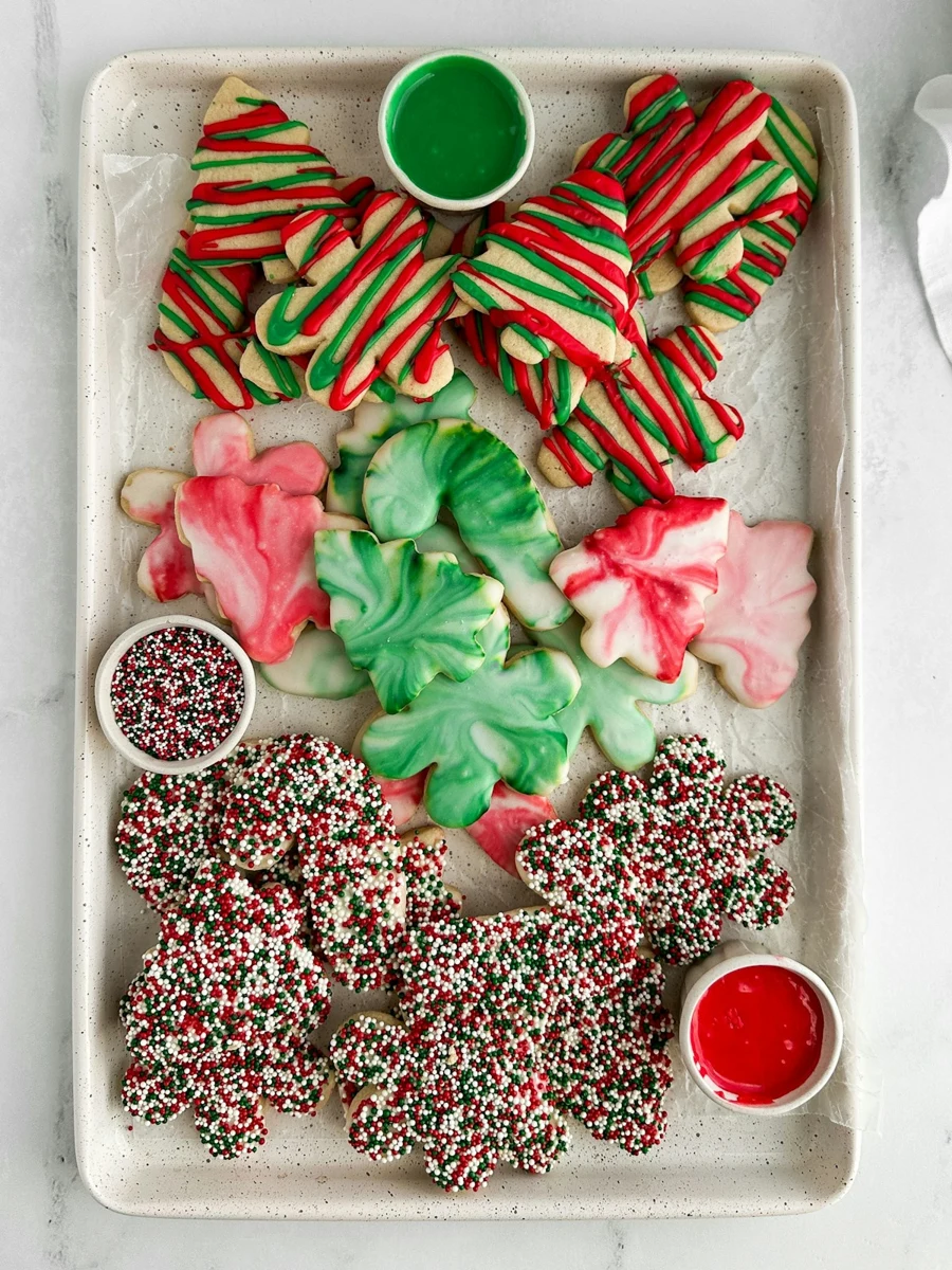 Representative iced cookies decorated with coloured frosting and sprinkles