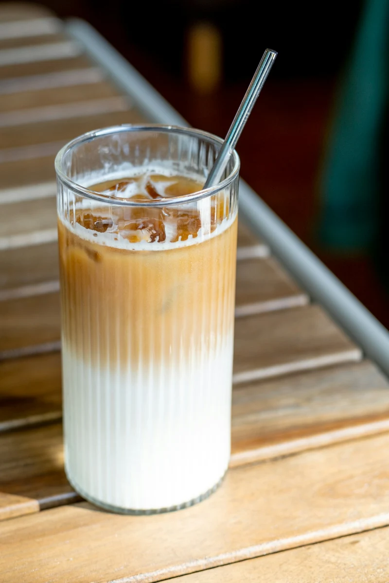 Representative iced coffee with milk in a ribbed glass