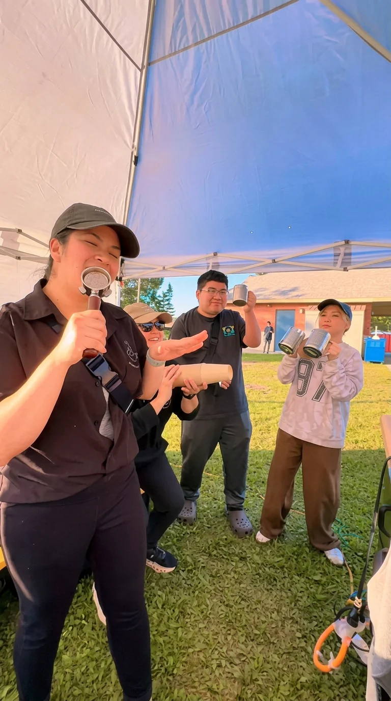 The Bake-a-Wish team serving drinks under a tent at an outdoor event